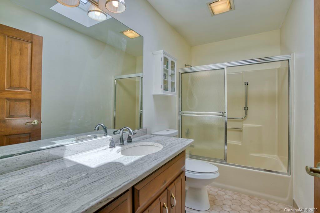 14 Holly Ridge Lane Tryon, NC 28782 - Photo 29 of 42 a bathroom with a granite countertop sink toilet and shower