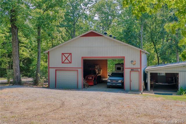 14 Holly Ridge Lane Tryon, NC 28782 - Photo 33 of 42 a view of a house with a garage and a car parked in it