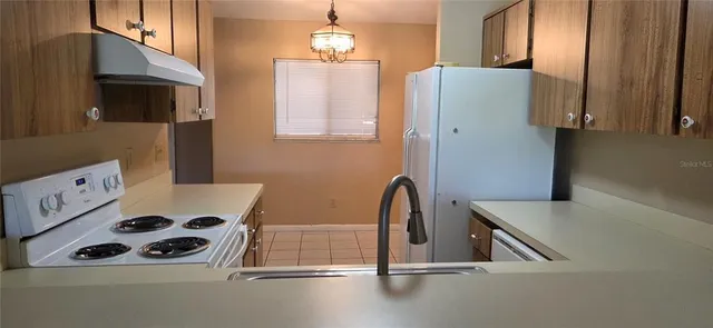 a kitchen with a sink and a refrigerator