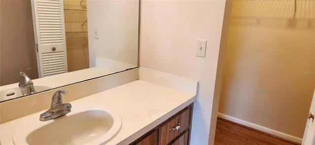 a bathroom with a granite countertop shower and a toilet
