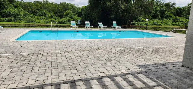 a large building with swimming pool in front of it