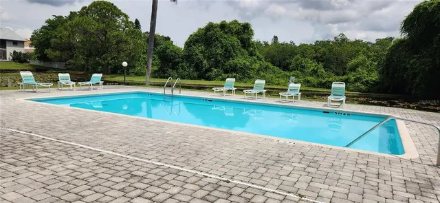 a dining room with furniture a rug and a painting