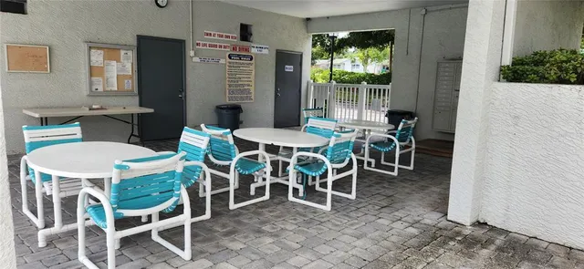 a view of a house with swimming pool and sitting area