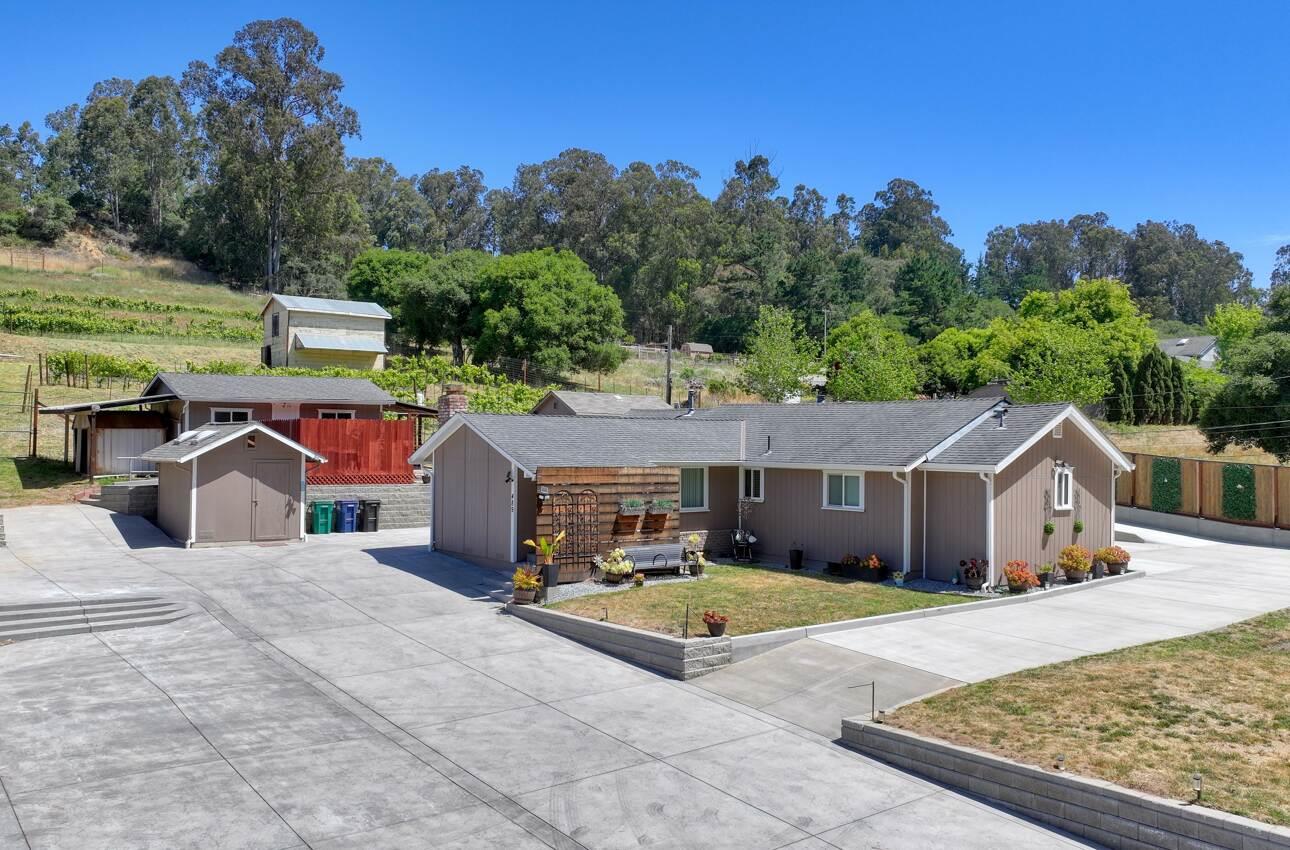 an aerial view of a house with yard