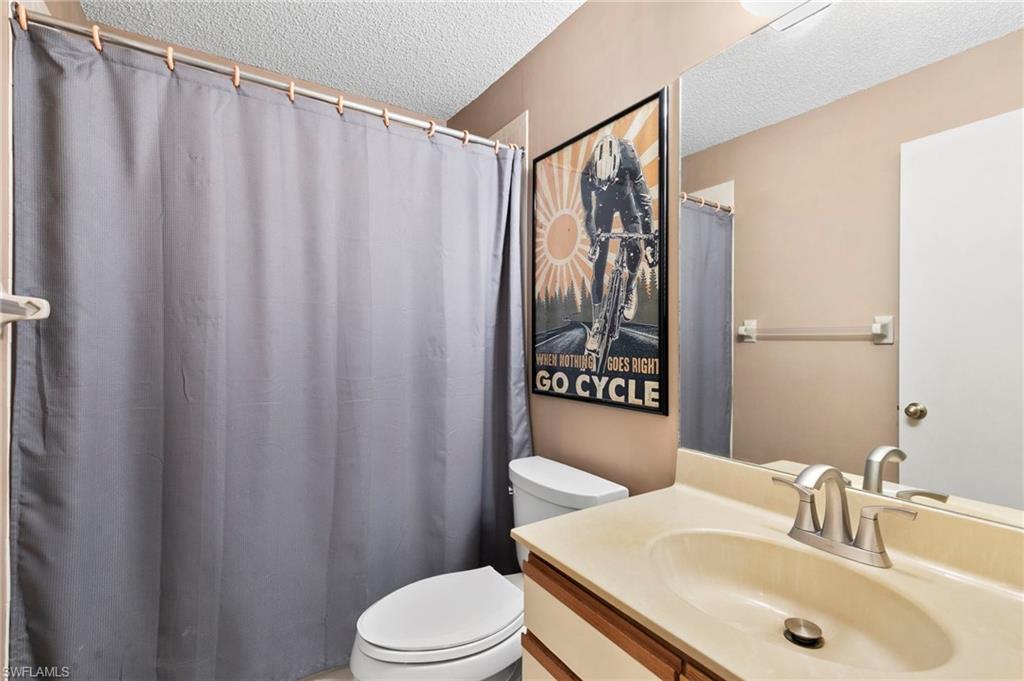 236 Pebble Beach Circle, Unit A202 Naples, FL 34113 - Photo 16 of 25 a bathroom with a sink and toilet