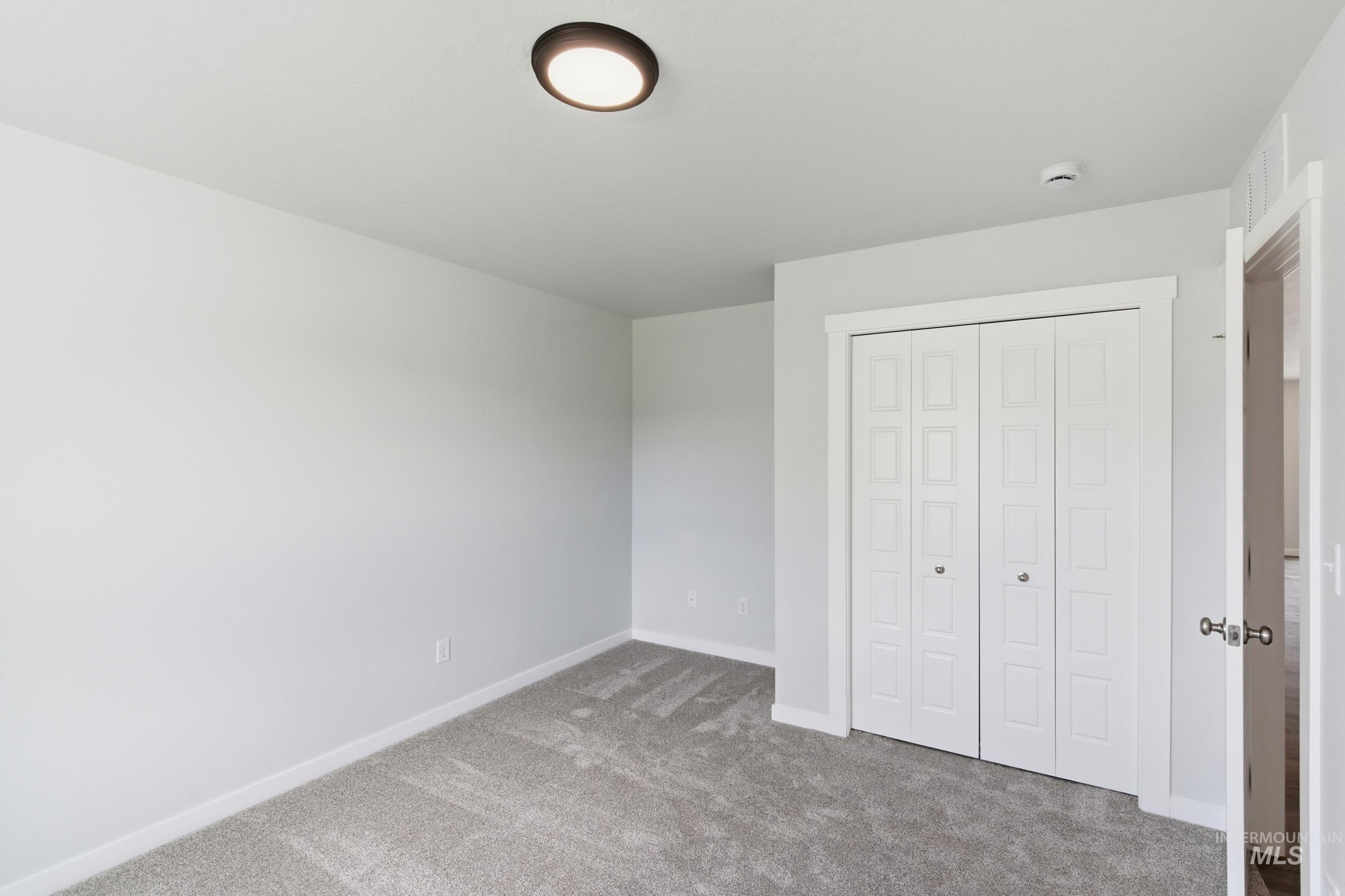 12829 Decatur Street Nampa, ID 83651 - Photo 13 of 33 Neutral tone walls with light gray carpeting