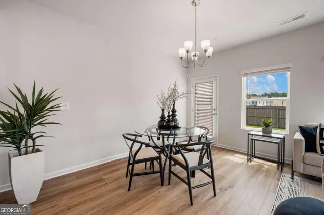 a view of a dining room with furniture window and wooden floor