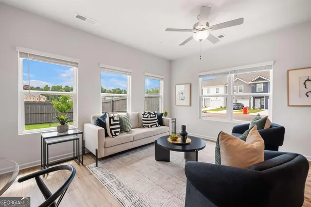 a living room with furniture and a large window