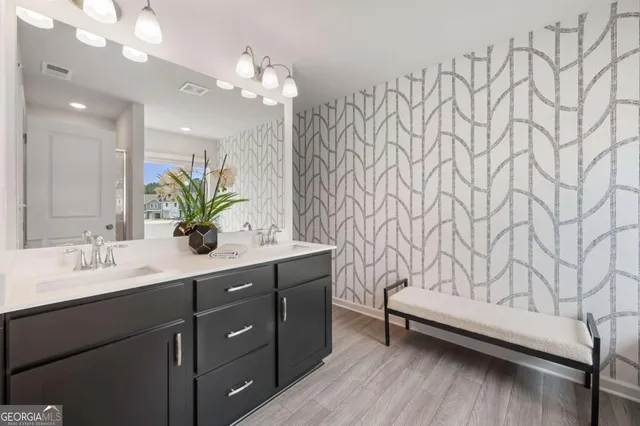 a bathroom with a sink vanity granite and a mirror