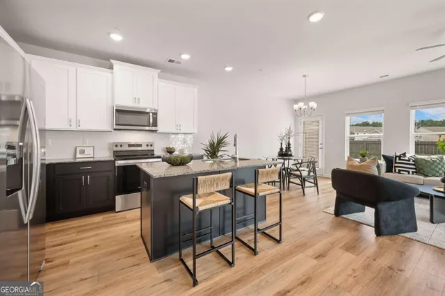 a kitchen with a sink cabinets and wooden floor