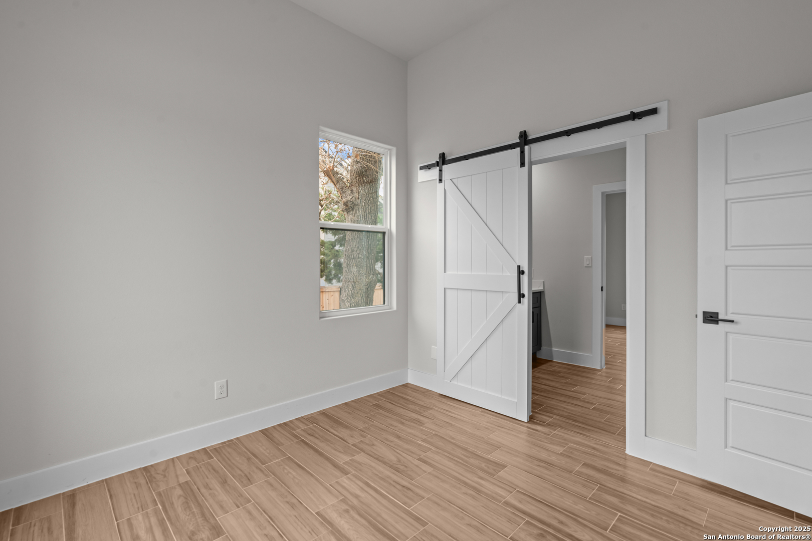 103 Robert Sloan Blanco, TX 78606 - Photo 9 of 10 a view of an empty room with wooden floor and a window