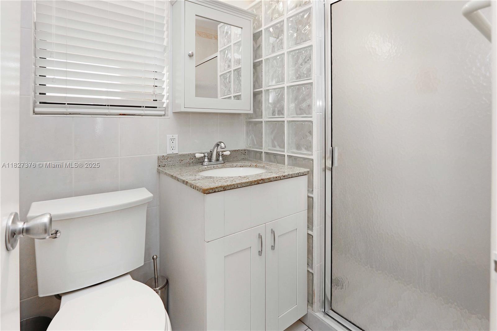 3300 North Surf Road, Unit 3A Hollywood, FL 33019 - Photo 20 of 39 a bathroom with a sink toilet and vanity