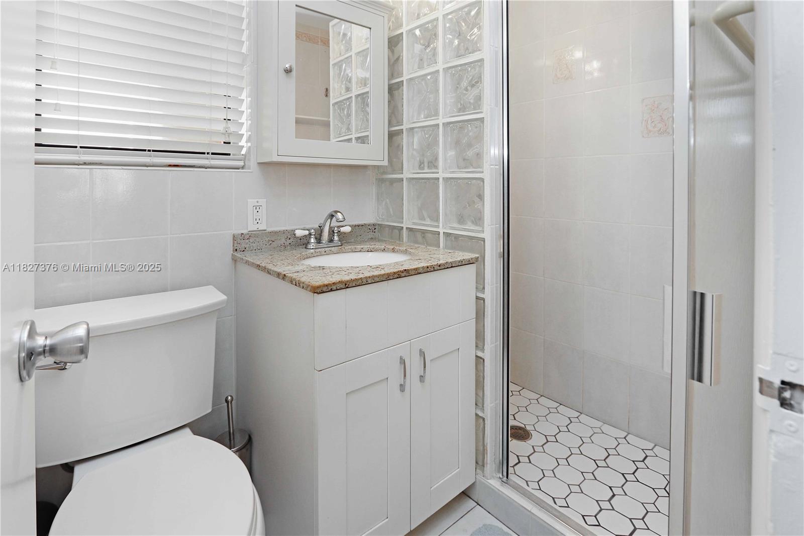 3300 North Surf Road, Unit 3A Hollywood, FL 33019 - Photo 22 of 39 a bathroom with a granite countertop sink toilet and shower