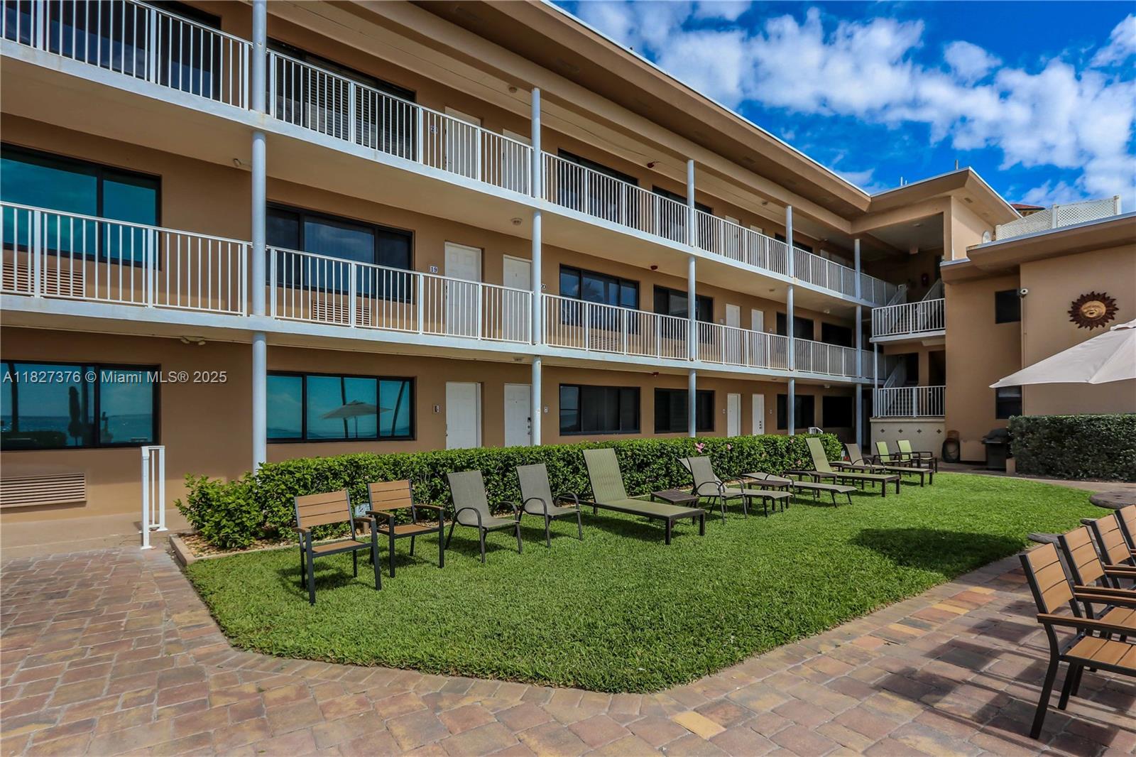 3300 North Surf Road, Unit 3A Hollywood, FL 33019 - Photo 31 of 39 a front view of a building with a garden and plants