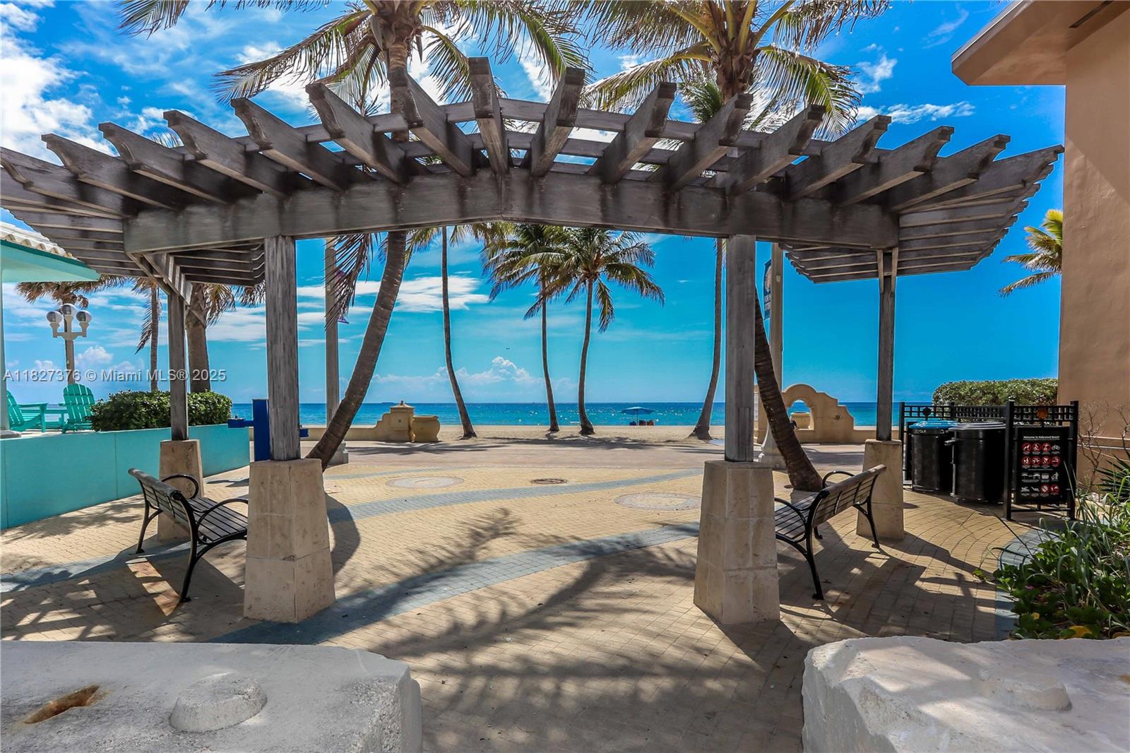 3300 North Surf Road, Unit 3A Hollywood, FL 33019 - Photo 36 of 39 a view of a patio with a table and chairs under an umbrella with a tub
