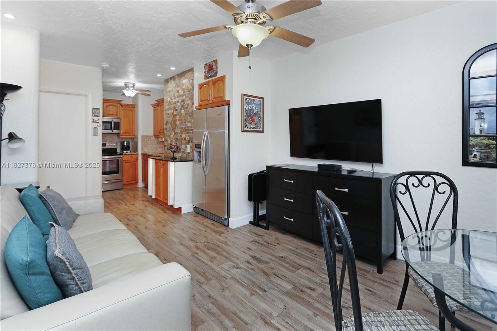 3300 North Surf Road, Unit 3A Hollywood, FL 33019 - Photo 5 of 39 a living room with furniture and a flat screen tv