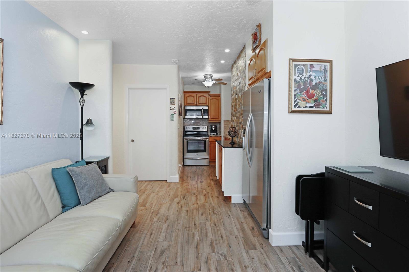 3300 North Surf Road, Unit 3A Hollywood, FL 33019 - Photo 6 of 39 a living room with furniture and a flat screen tv