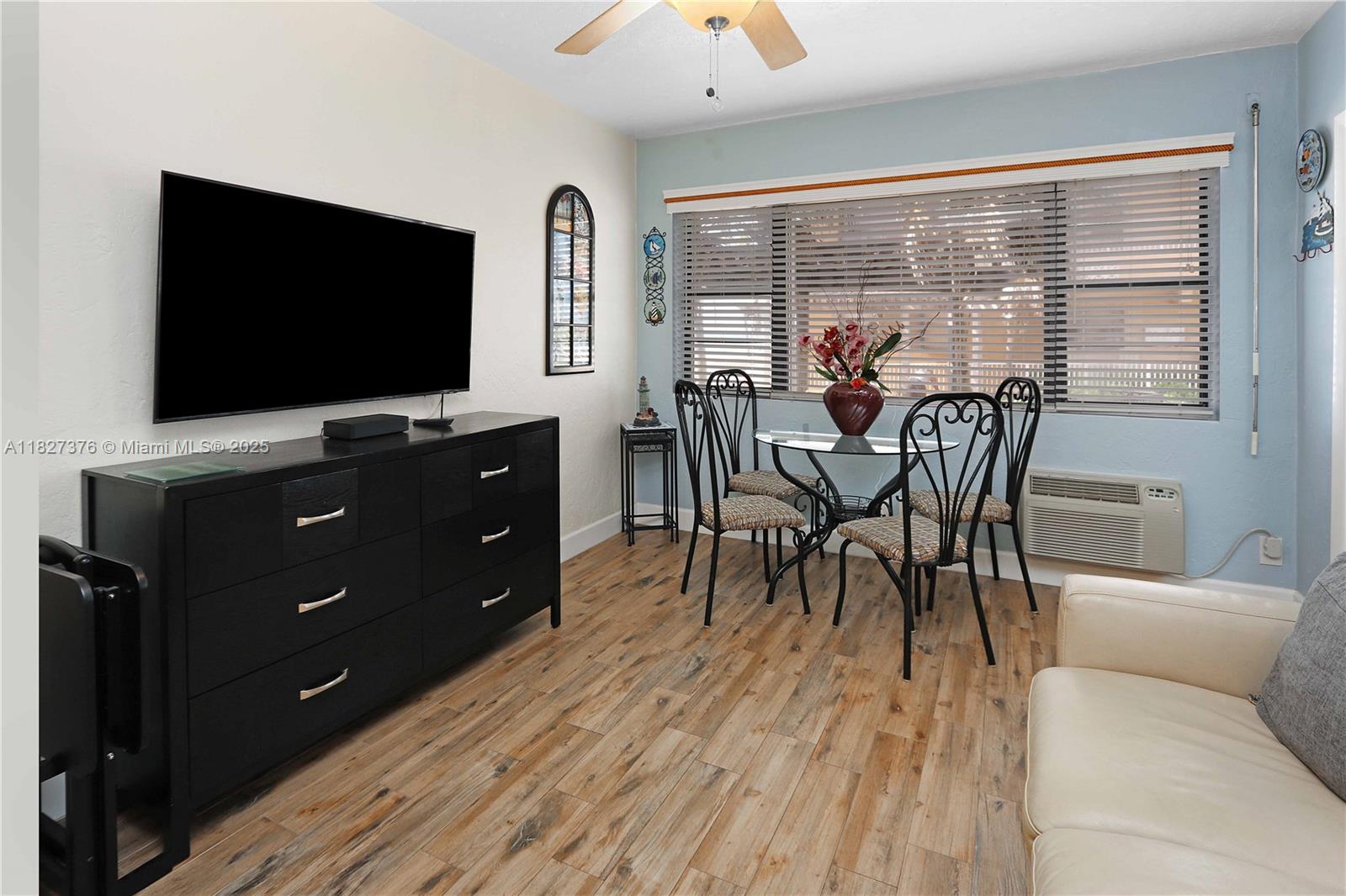 3300 North Surf Road, Unit 3A Hollywood, FL 33019 - Photo 7 of 39 a view of a dining room with furniture and a flat screen tv
