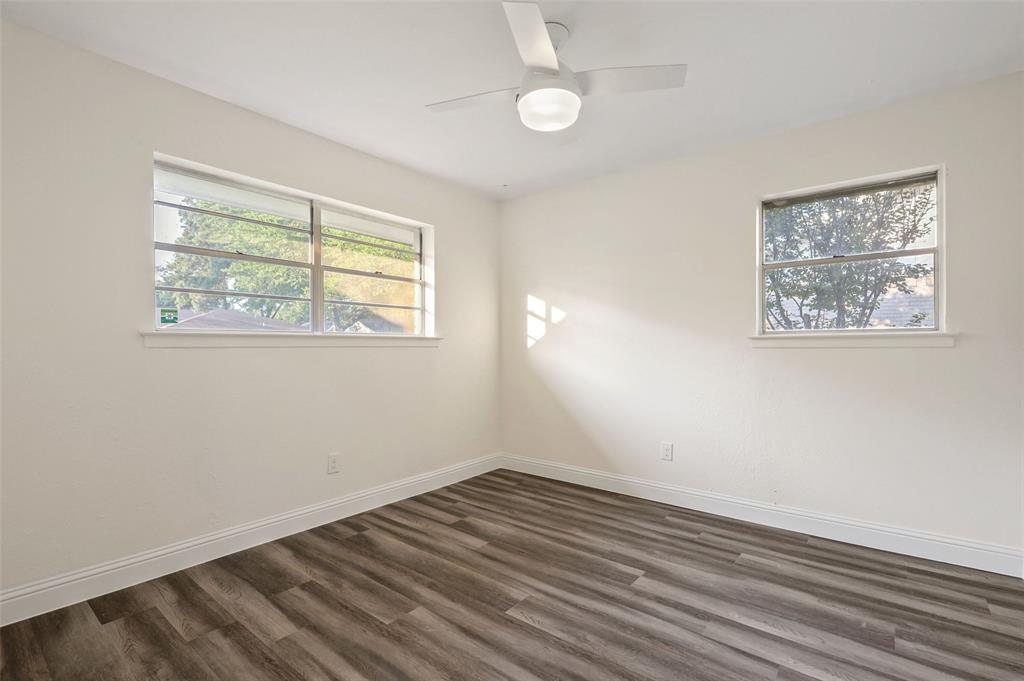 3126 Jubilee Trail Dallas, TX 75229 - Photo 22 of 38 a view of an empty room with wooden floor and a window
