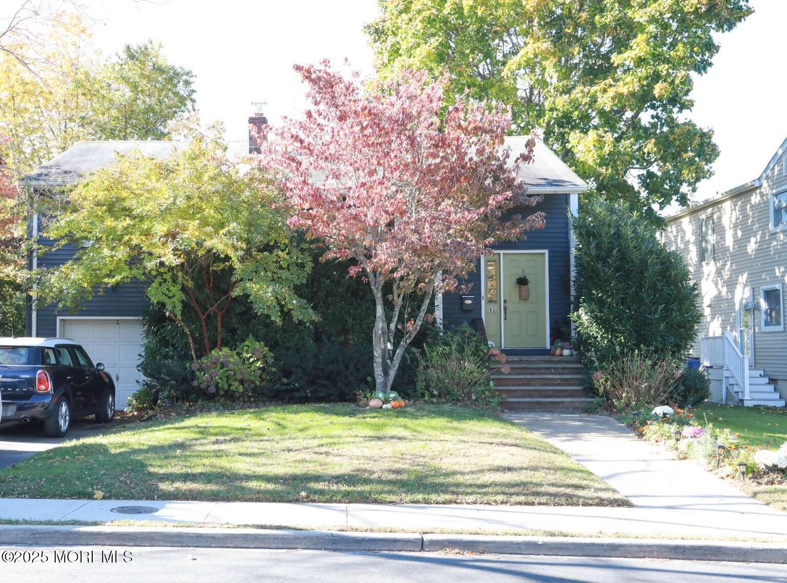 a house that has a tree in front of it