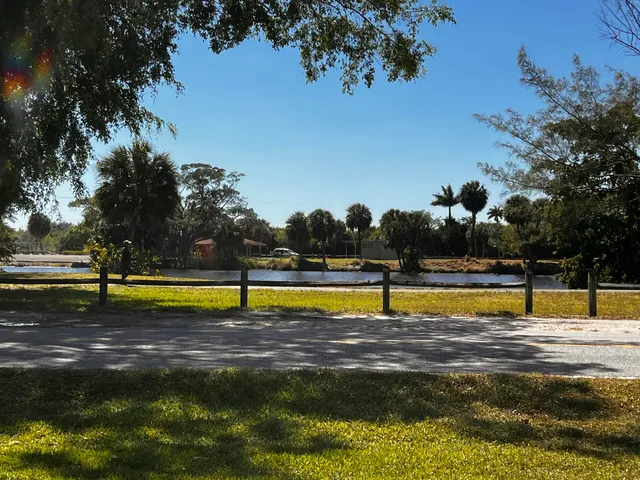 a view of swimming pool with outdoor seating and trees