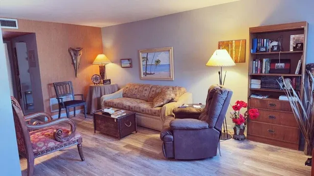 a living room with furniture and a lamp