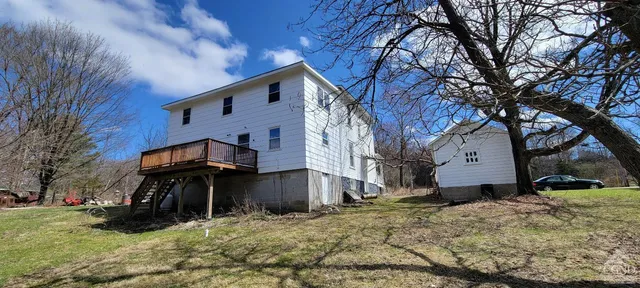 a view of a livingroom with furniture and a hallway