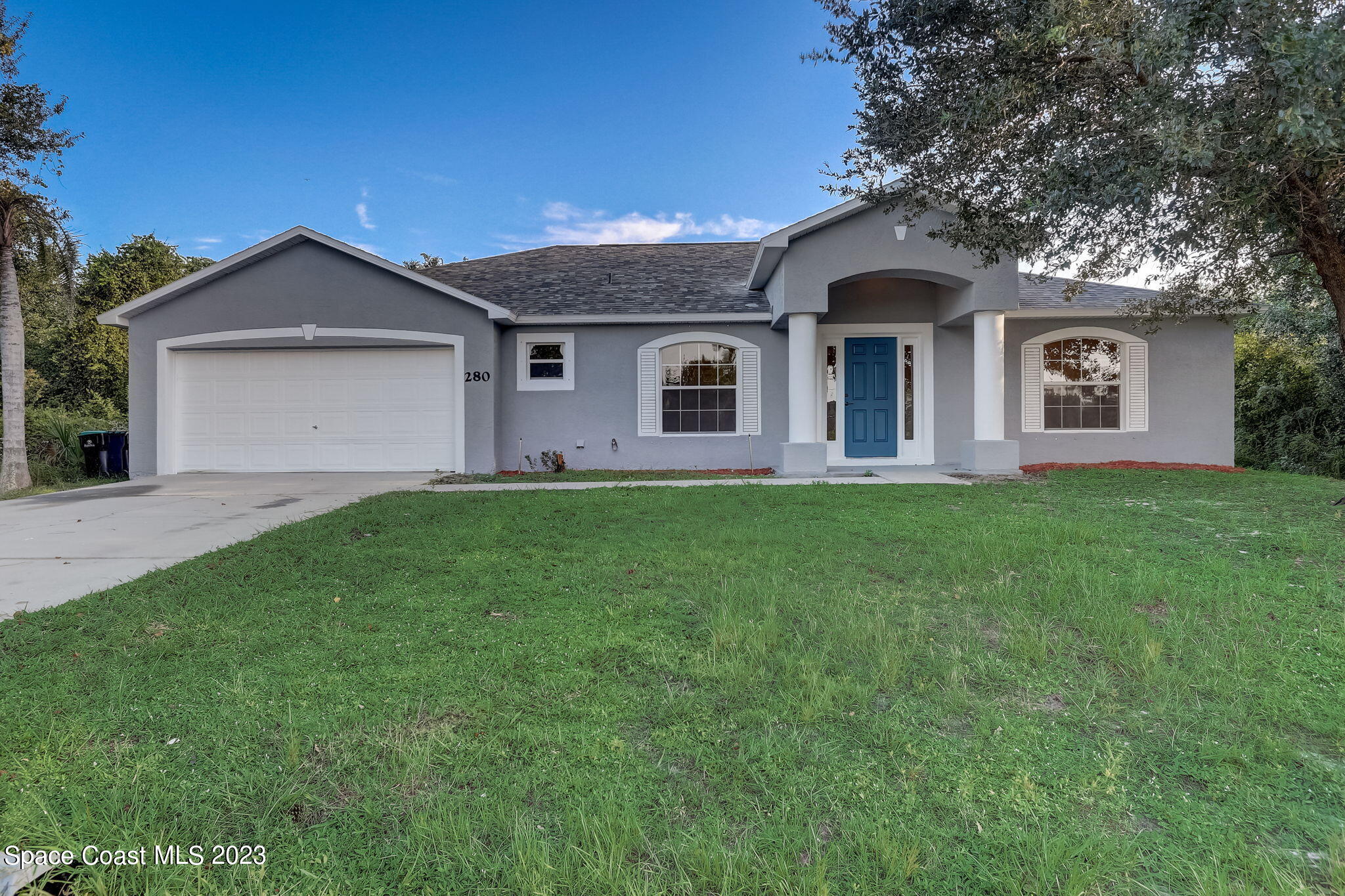 280 Gamewell Road Southwest Palm Bay, FL 32908 - Photo 1 of 19 a front view of house with yard and green space