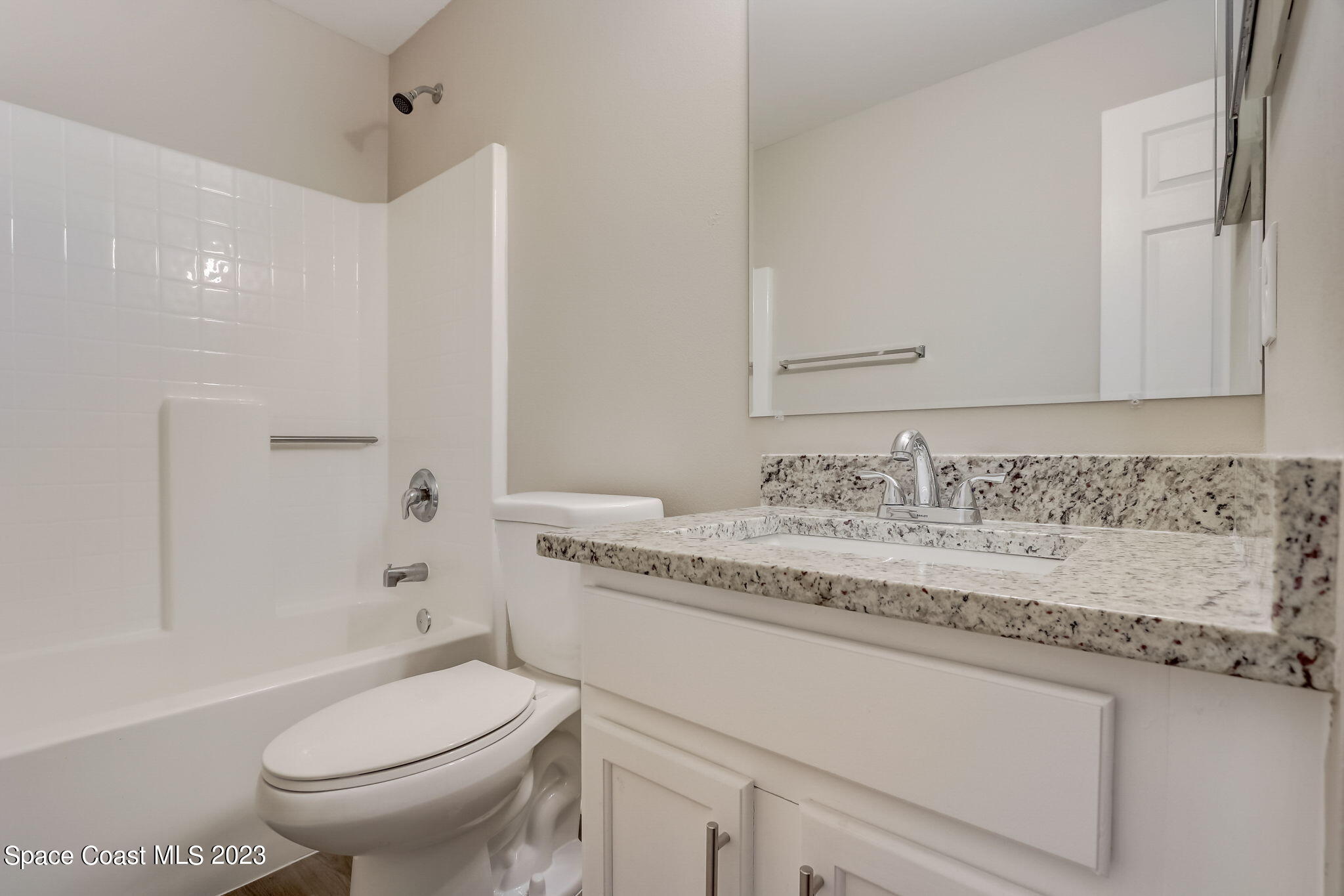 280 Gamewell Road Southwest Palm Bay, FL 32908 - Photo 11 of 19 a bathroom with a granite countertop toilet sink and mirror