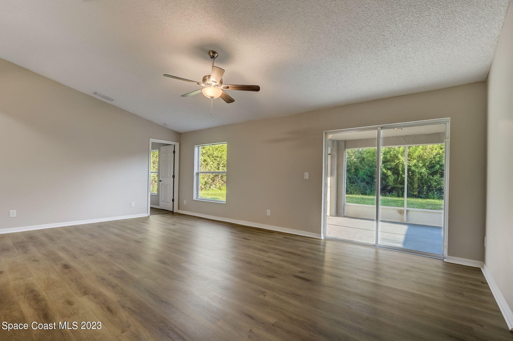 280 Gamewell Road Southwest Palm Bay, FL 32908 - Photo 2 of 19 a view of empty room with wooden floor and fan