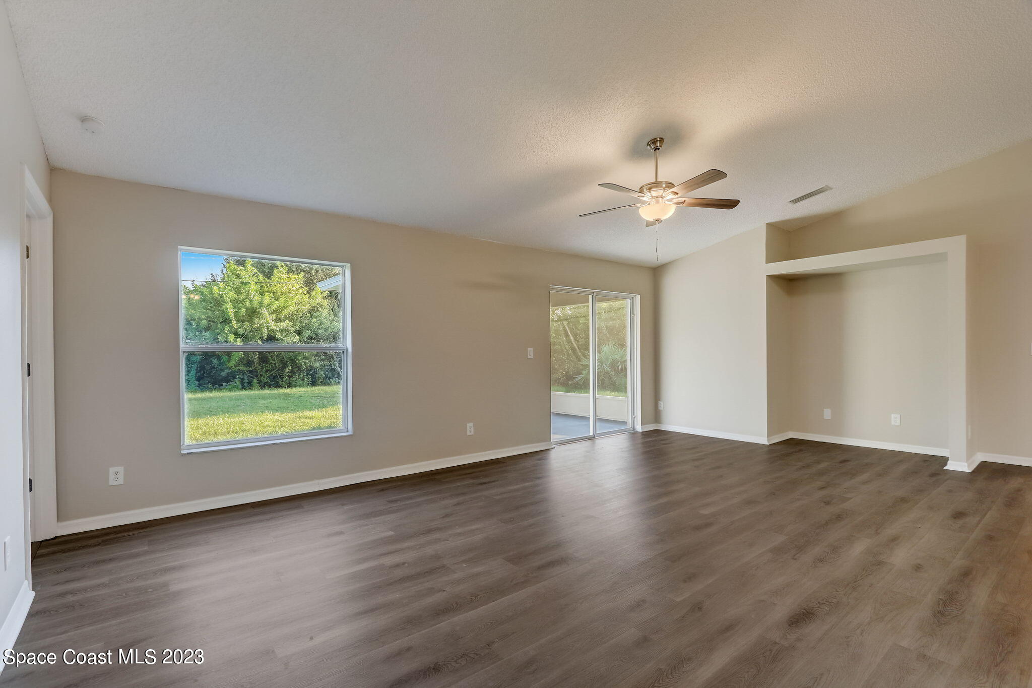 280 Gamewell Road Southwest Palm Bay, FL 32908 - Photo 5 of 19 a view of an empty room with a window and a ceiling fan