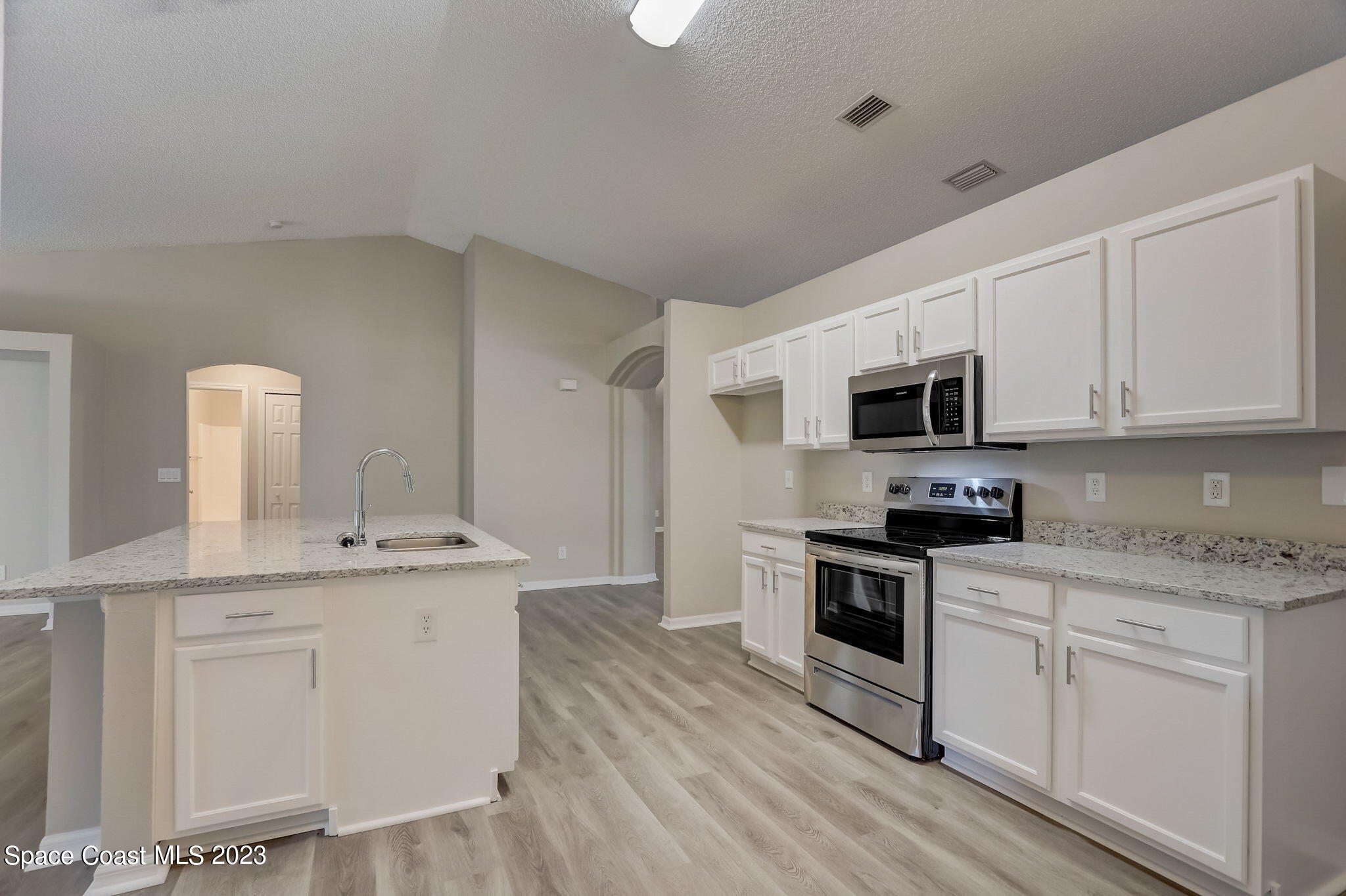 280 Gamewell Road Southwest Palm Bay, FL 32908 - Photo 7 of 19 a kitchen with stainless steel appliances granite countertop a sink a stove a microwave and cabinets