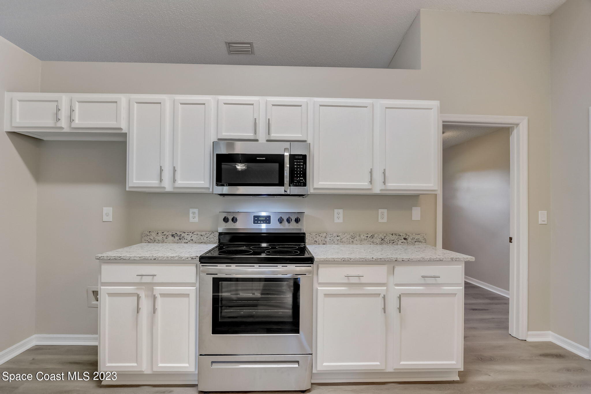 280 Gamewell Road Southwest Palm Bay, FL 32908 - Photo 8 of 19 a kitchen with white cabinets stainless steel appliances and sink