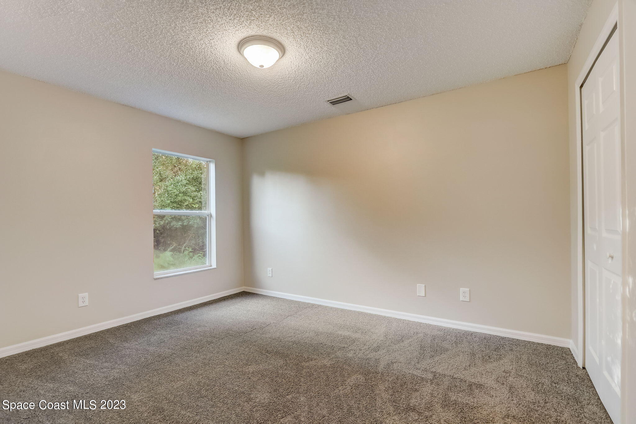 280 Gamewell Road Southwest Palm Bay, FL 32908 - Photo 9 of 19 an empty room with windows