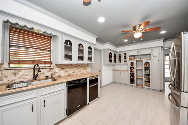 a kitchen with stainless steel appliances granite countertop a sink and cabinets