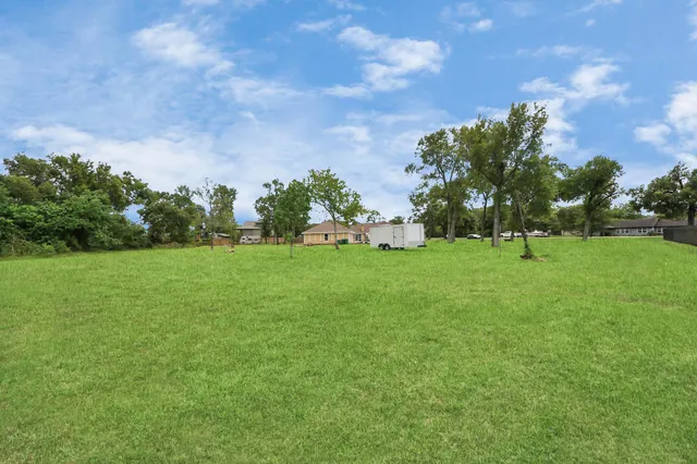 a view of grassy field with benches