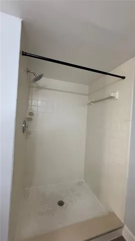 a bathroom with a glass shower door