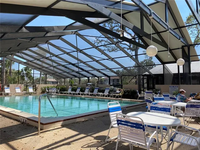a patio with water fountain table and chairs with an umbrella