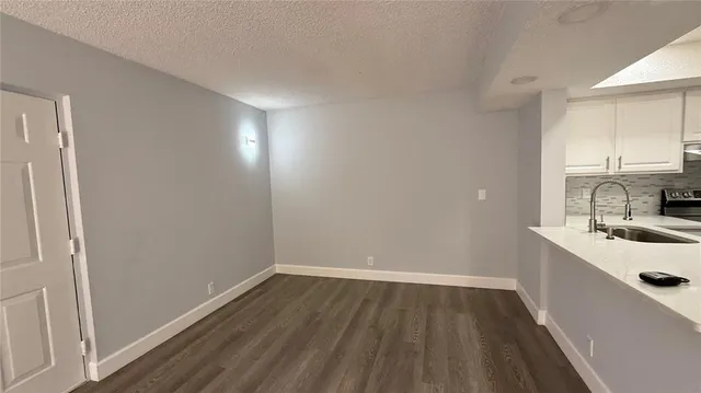 a room with a sink and cabinets