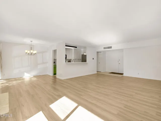 a kitchen with a sink cabinets and a wooden floor