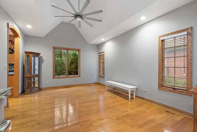 a dining hall with stainless steel appliances granite countertop a refrigerator a sink dishwasher with a dining table and chairs with wooden floor