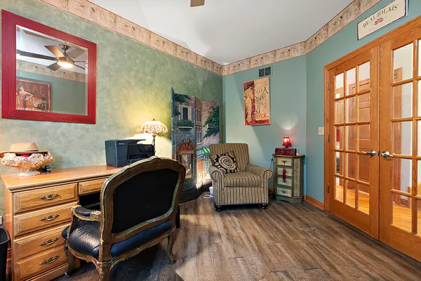 an empty room with windows and fan