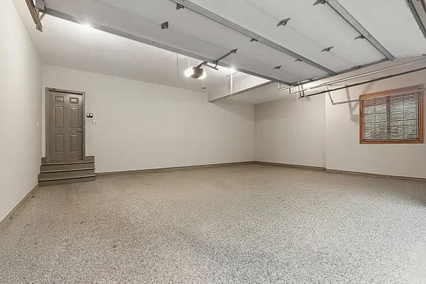 a view of a patio with table and chairs potted plants and large tree