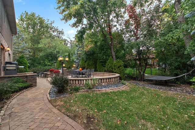 a garden with trees in the background