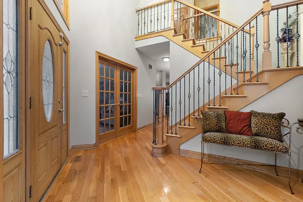 a view of entryway and hall with wooden floor