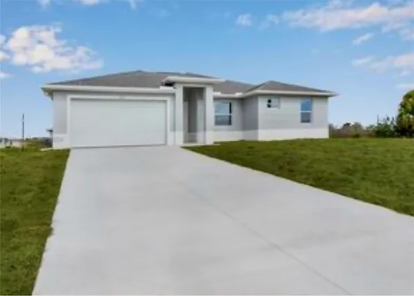 a view of a house with a yard and garage