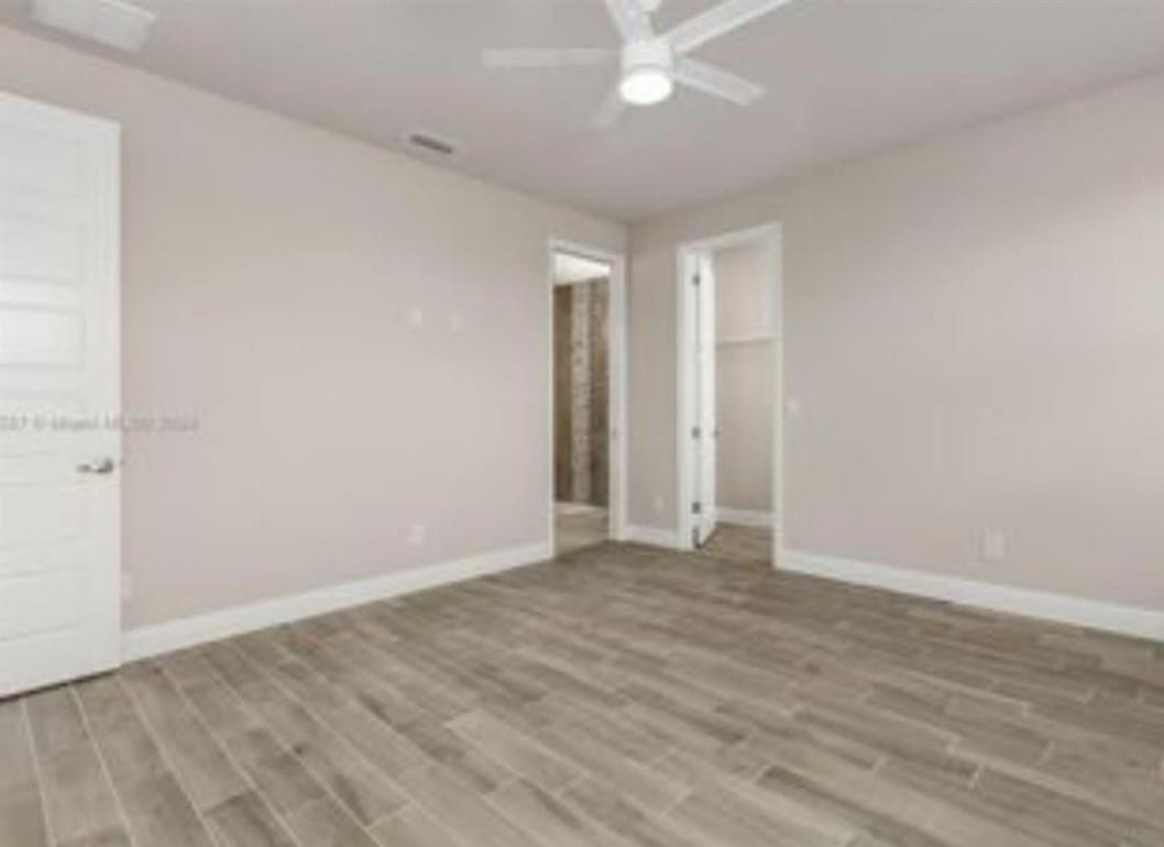 321 Neighborly Road LaBelle, FL 33935 - Photo 12 of 18 a view of an empty room with wooden floor
