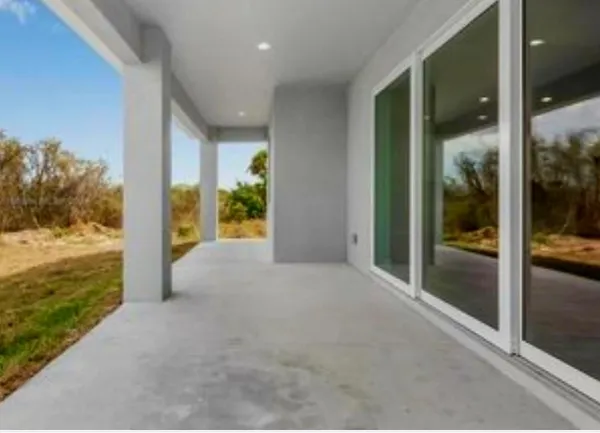 a view of a glass door and a yard