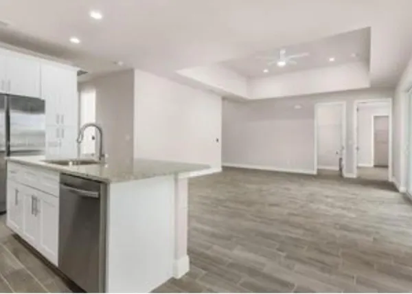 a kitchen with granite countertop a sink and a stove top oven