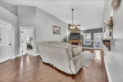 a living room with a fireplace with wooden floor
